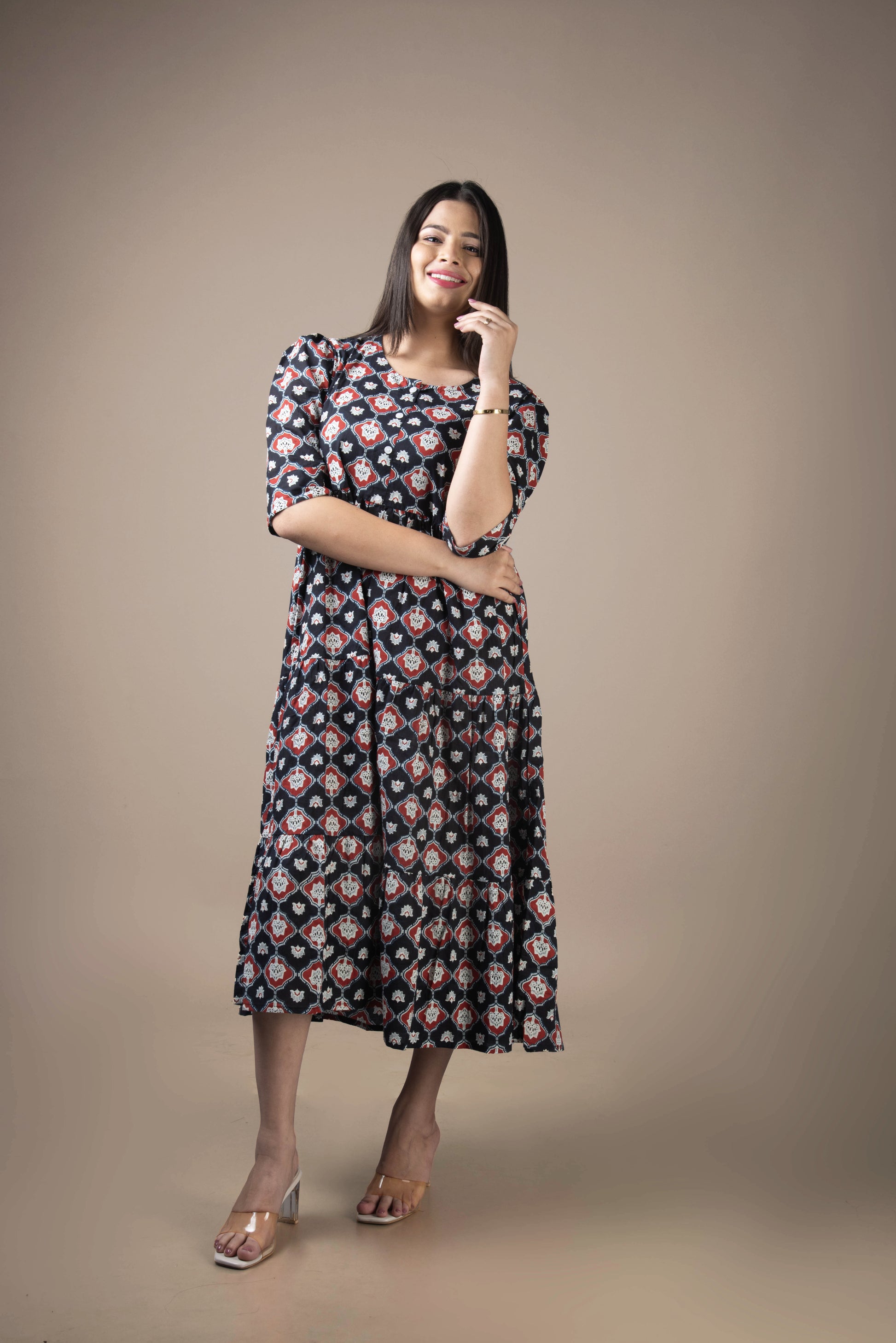 Woman wearing a floral dress against a plain background
