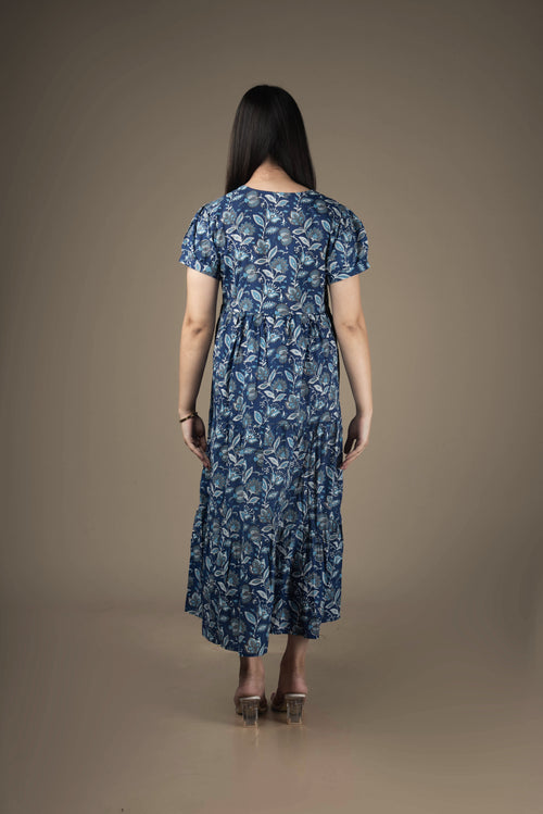 Woman wearing a blue floral dress against a brown background