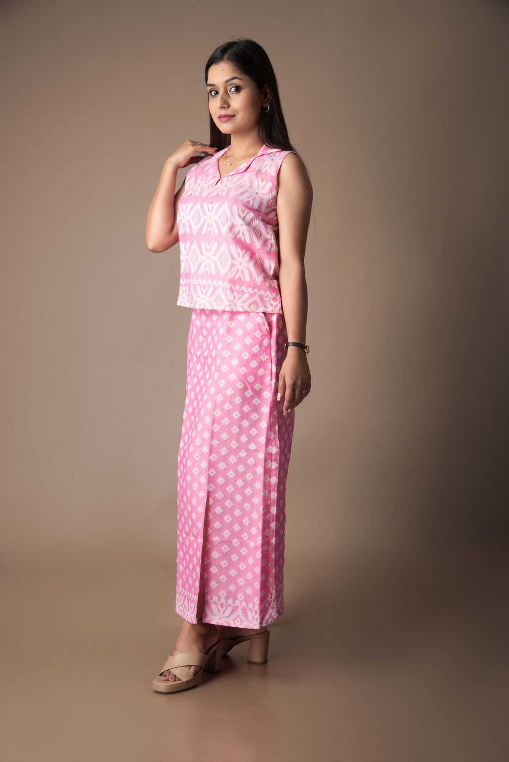 Woman wearing a pink jamdani traditional outfit with a plain background
