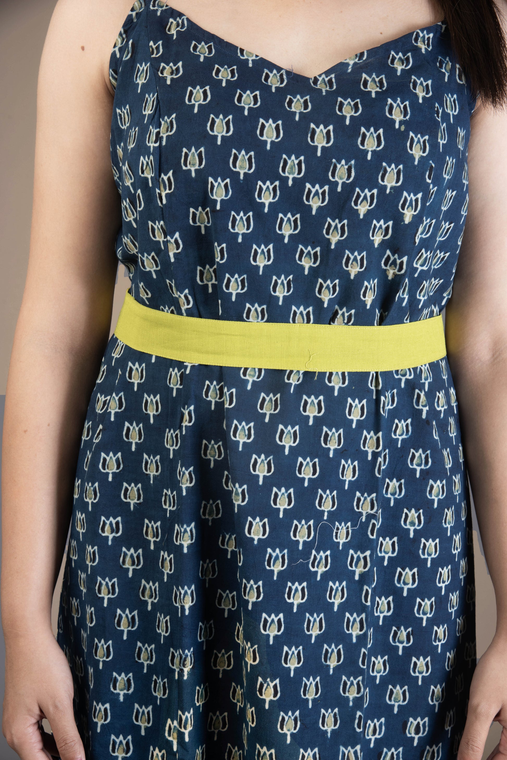 Navy dress with white floral pattern and yellow waistband