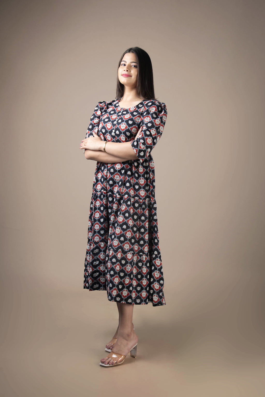 Woman wearing a floral dress against a plain background