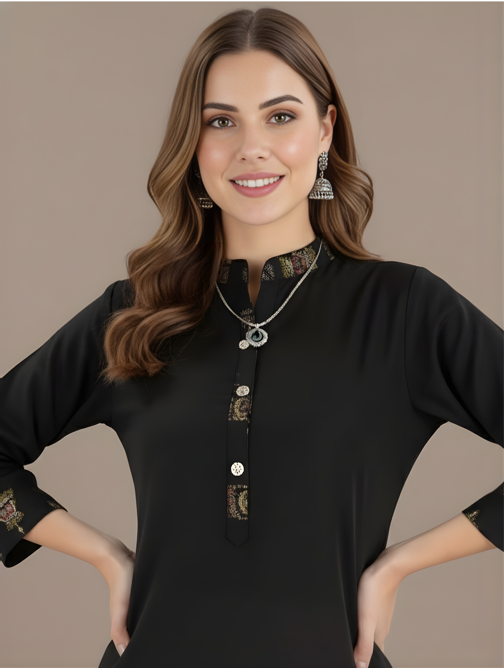 Woman wearing a black blouse with intricate designs on a beige background