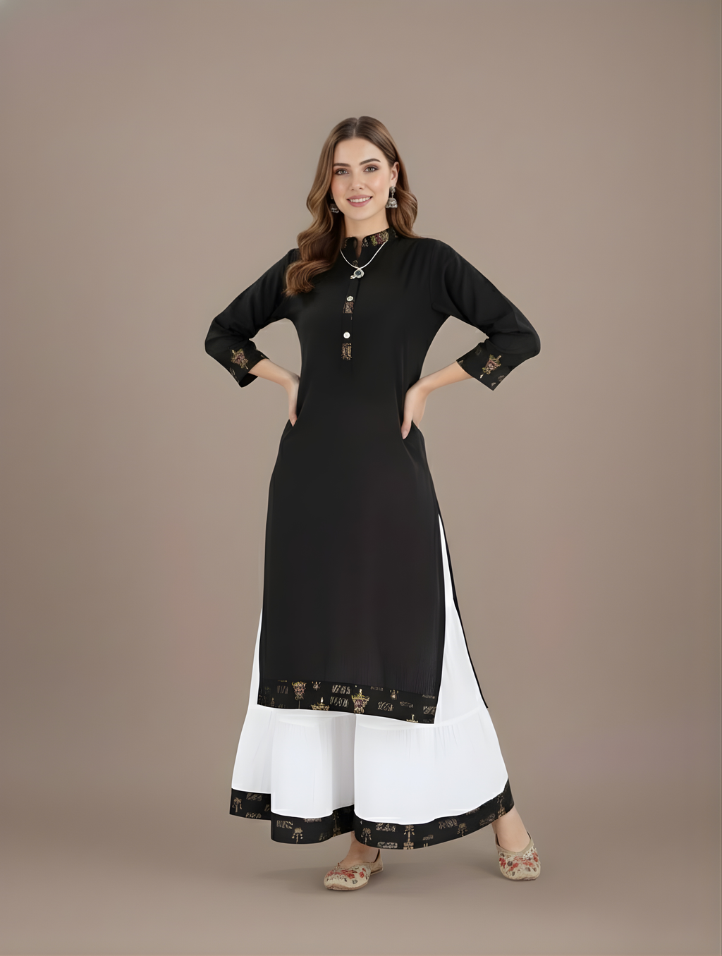 Woman wearing a black and white dress with intricate designs on a brown background