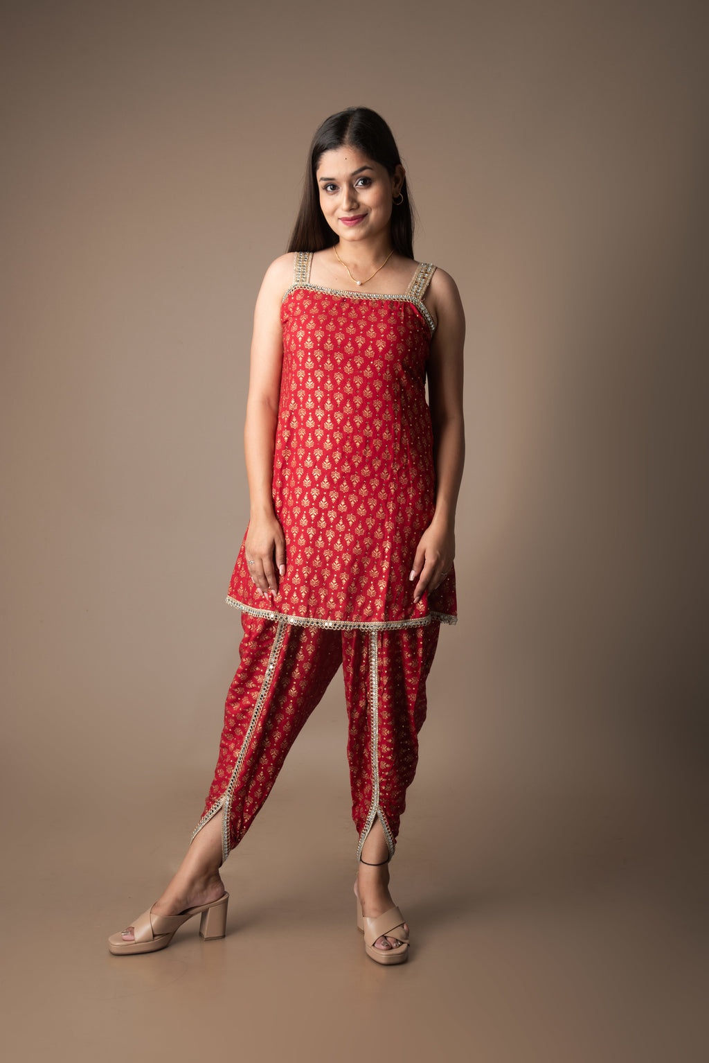 Woman wearing a red traditional outfit with a plain background