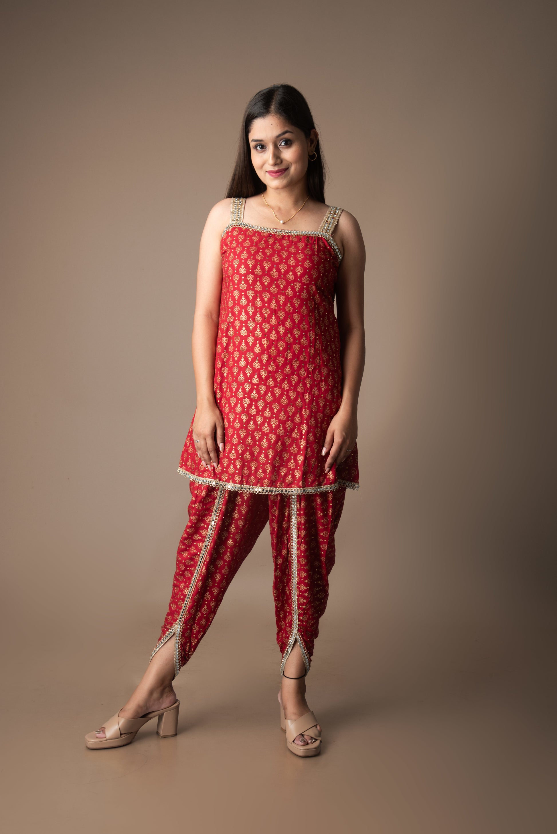 Woman wearing a red traditional outfit with a plain background