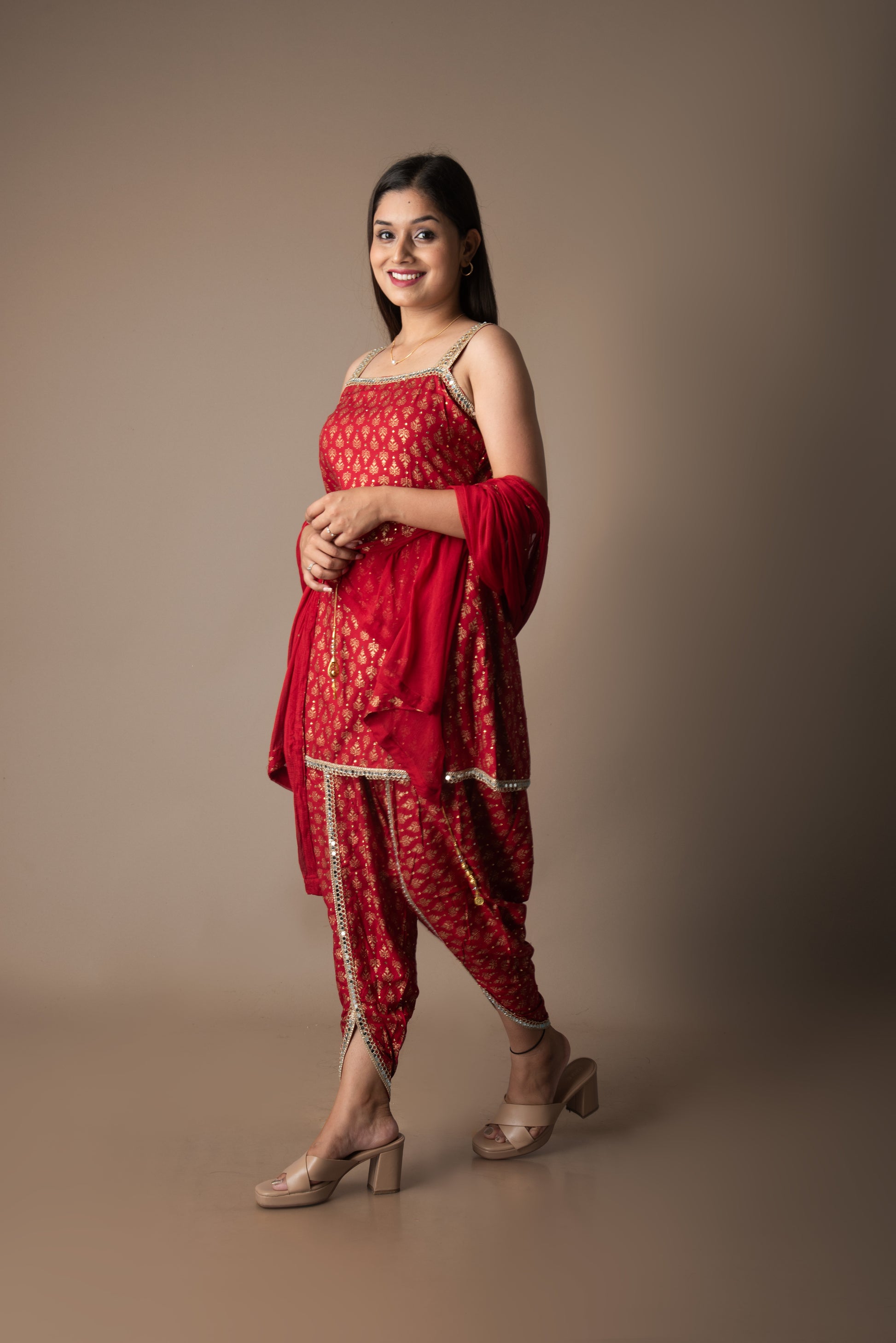 Woman wearing a red traditional outfit with a plain background