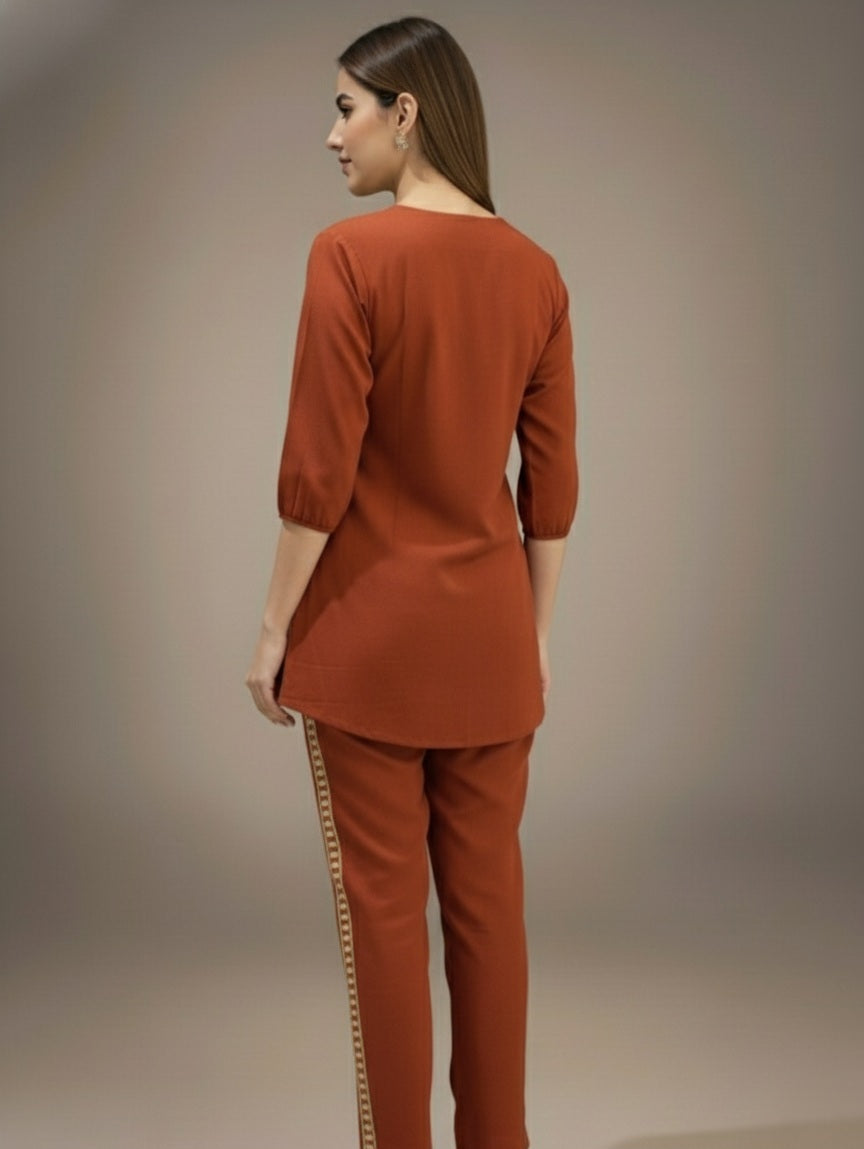 Woman wearing a rust-colored outfit with a plain background
