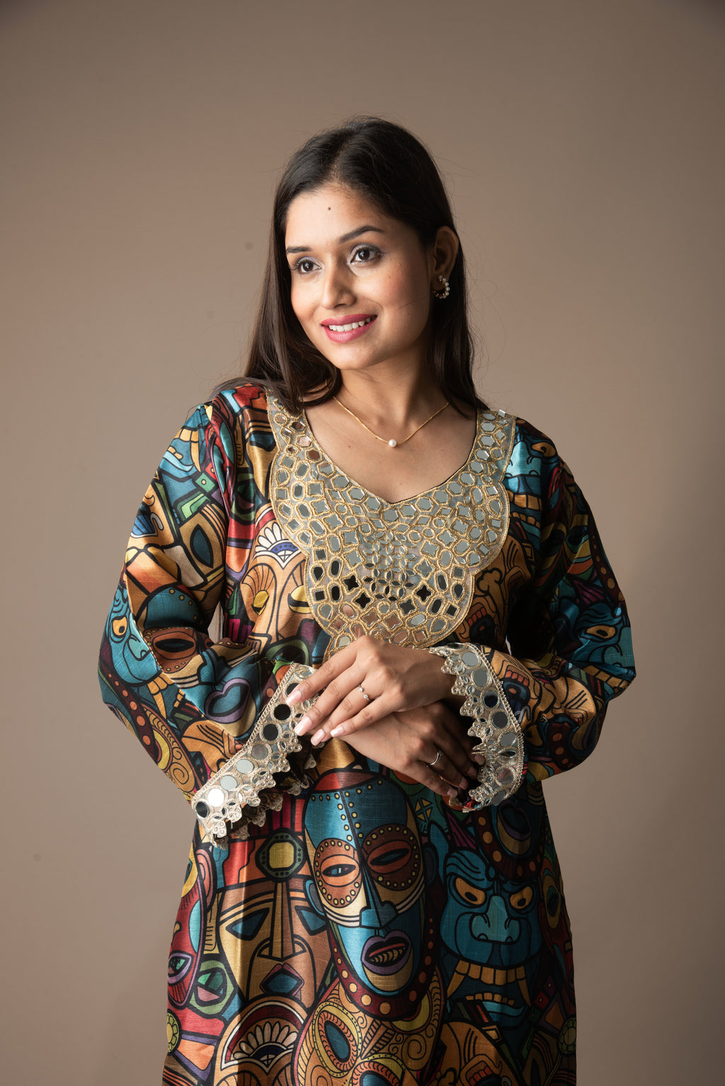 Woman wearing a colorful traditional outfit with intricate patterns on a plain background