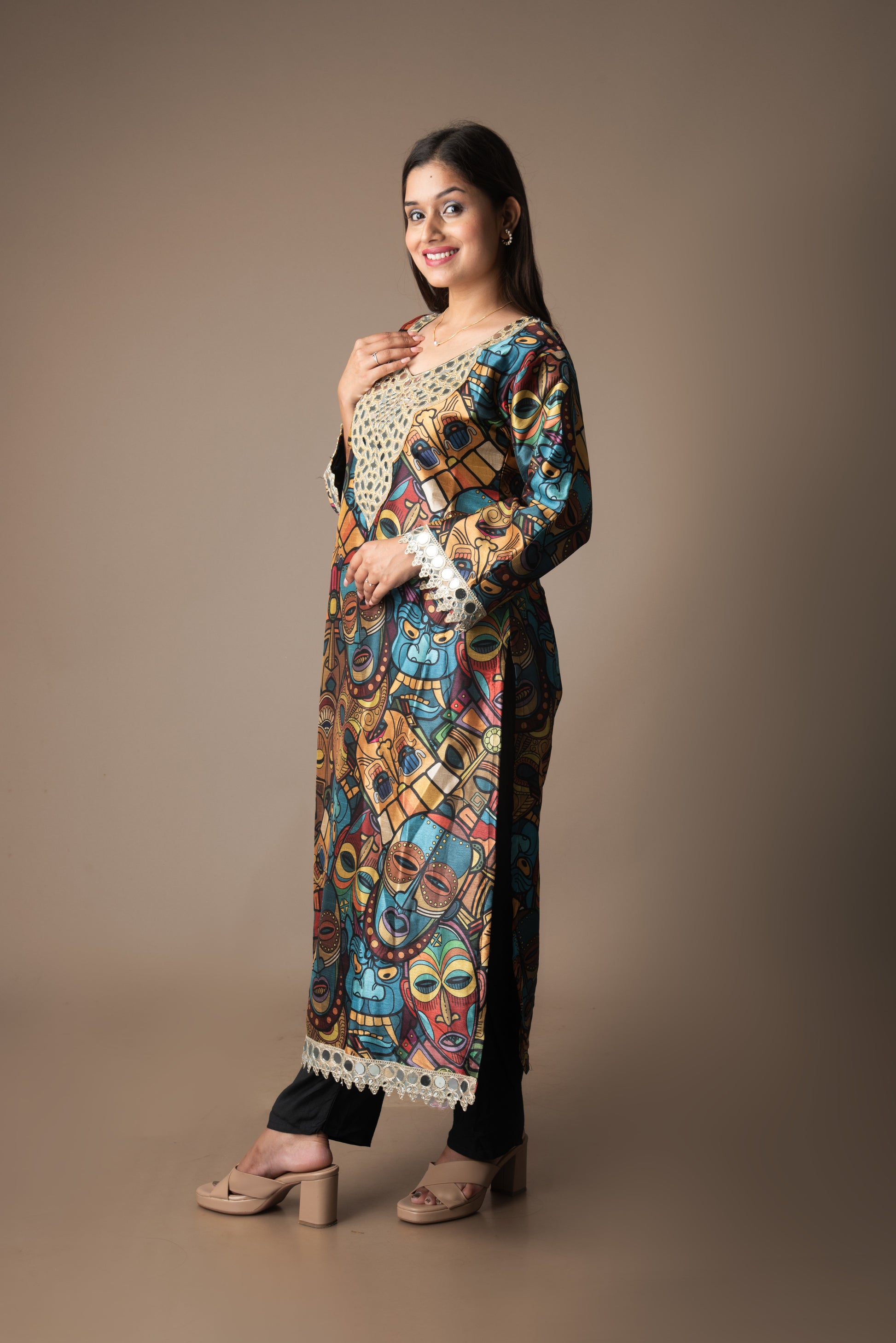 Woman wearing a colorful patterned kurta with a plain background