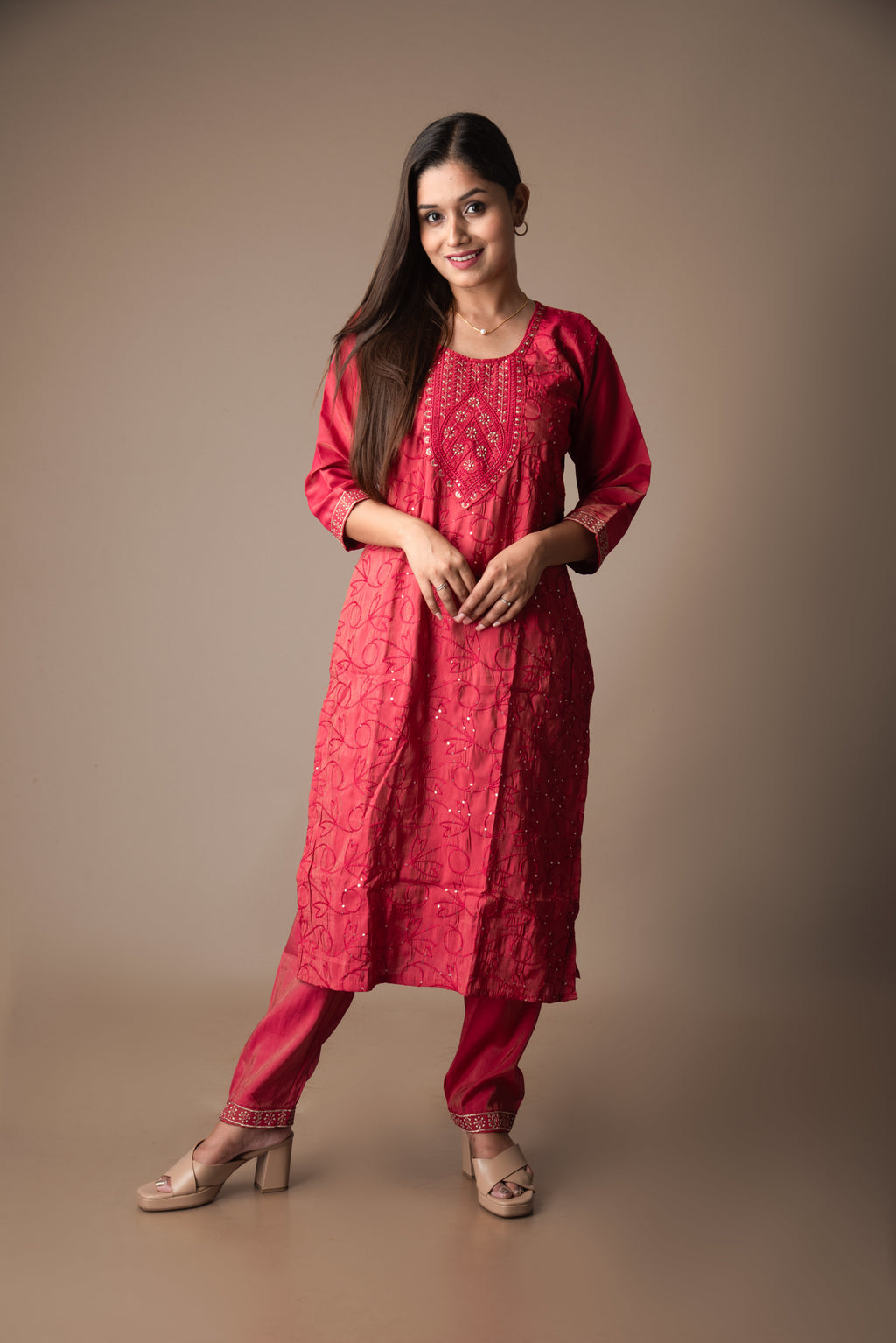Woman wearing a red traditional outfit on a brown background