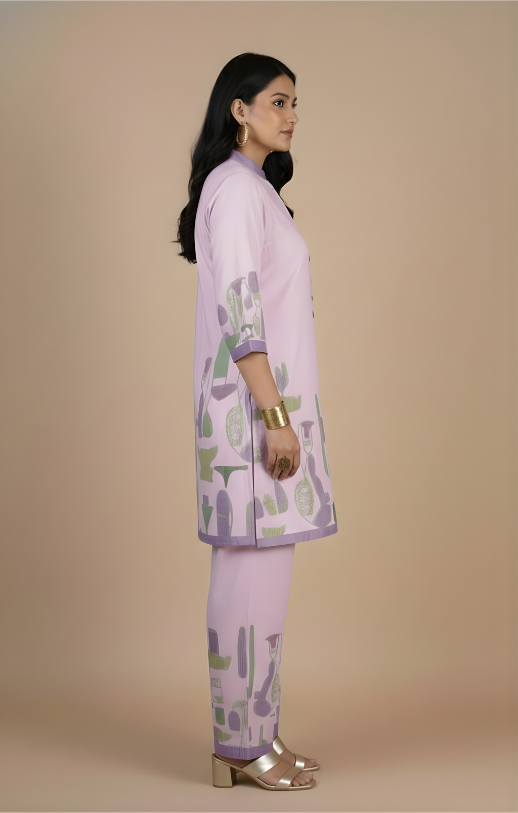 Woman wearing a light purple traditional outfit with green and purple patterns on a beige background