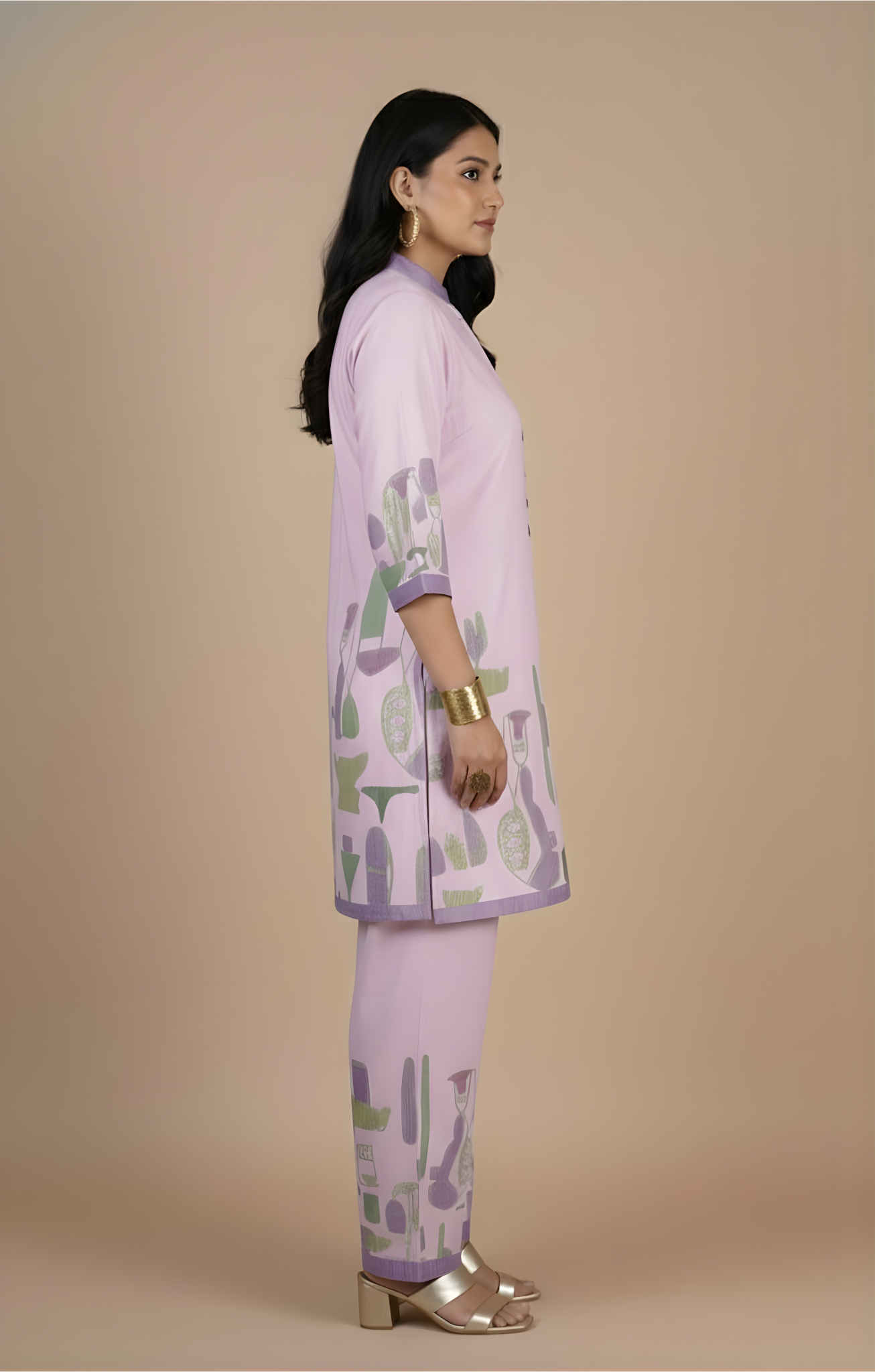 Woman wearing a light purple traditional outfit with green and purple patterns on a beige background